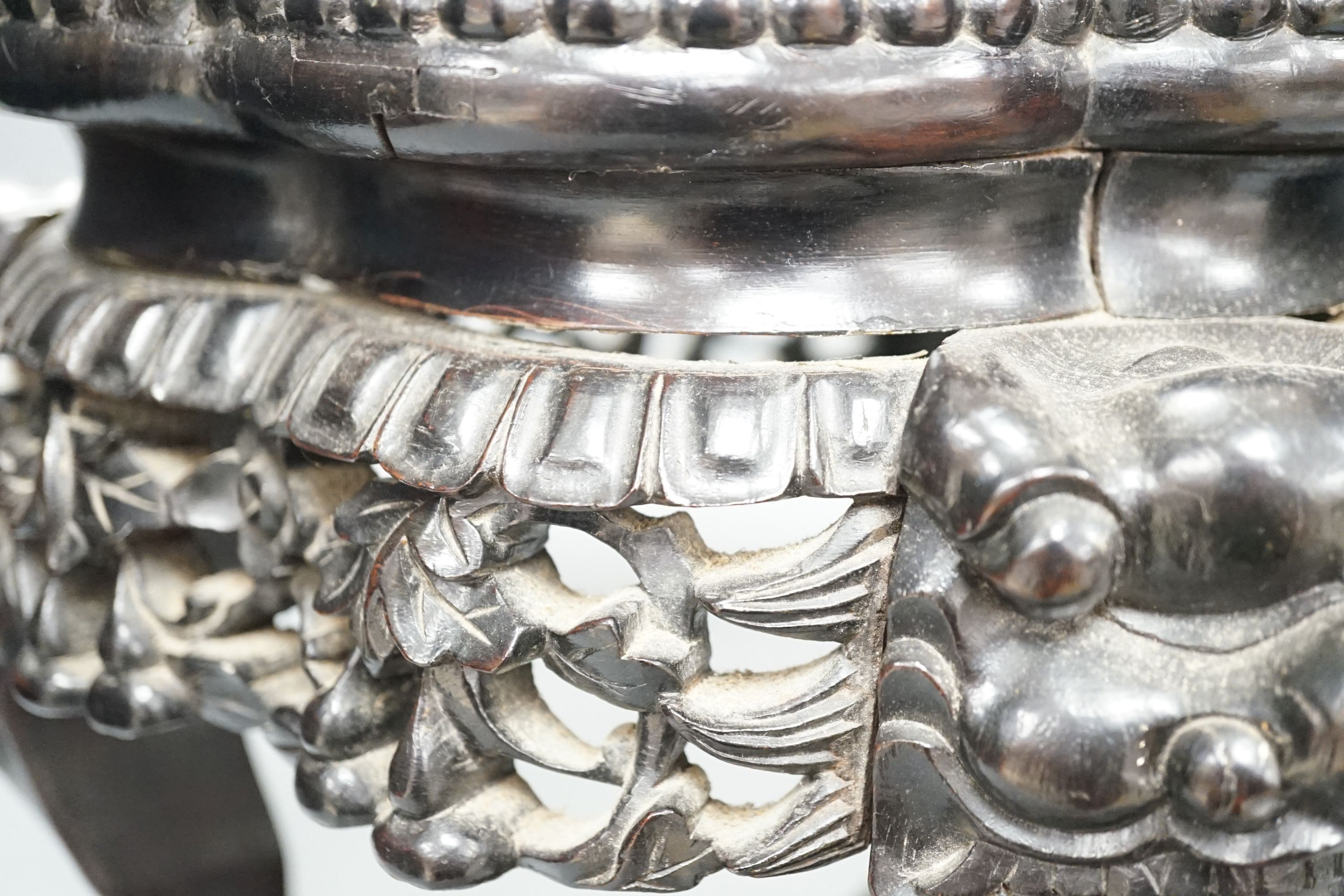 AChinese carved wood jardiniere stand, late Qing dynasty, with hard stone inset, top 26 cms diameter.
